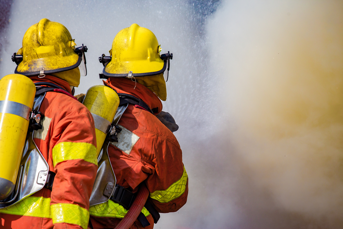Two Firefighters Water Spray By High Pressure Nozzle Surround Wi